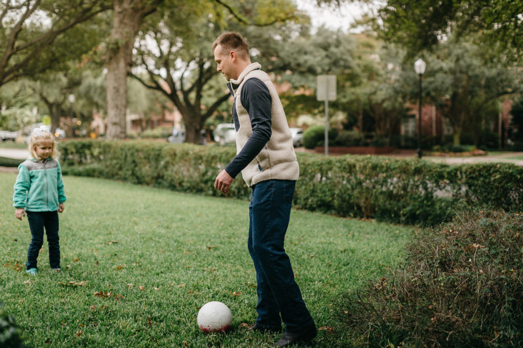 dad and daughter playing soccer