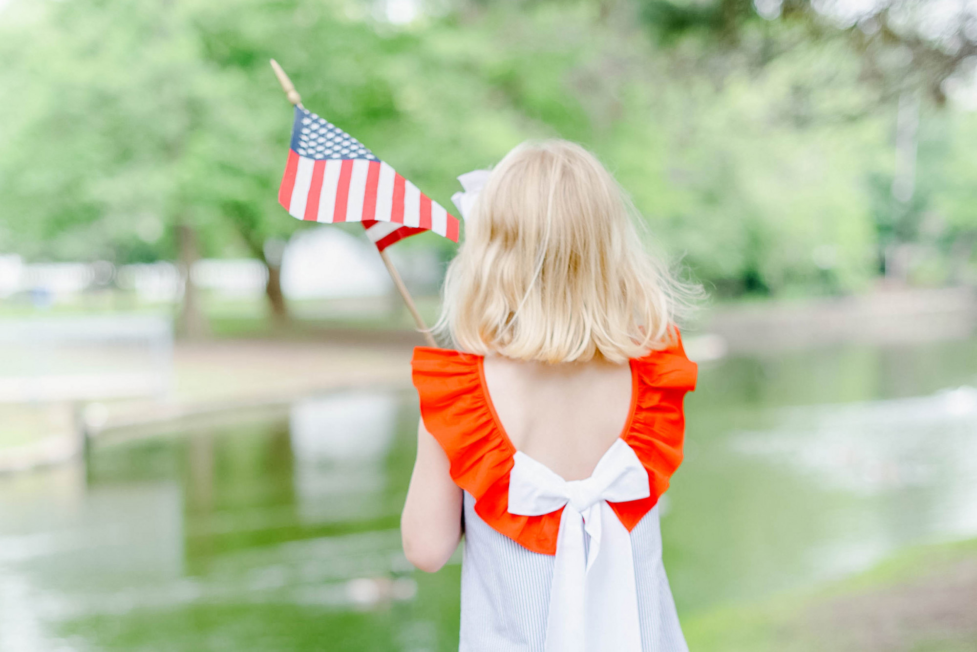 Girl holding small American Flag